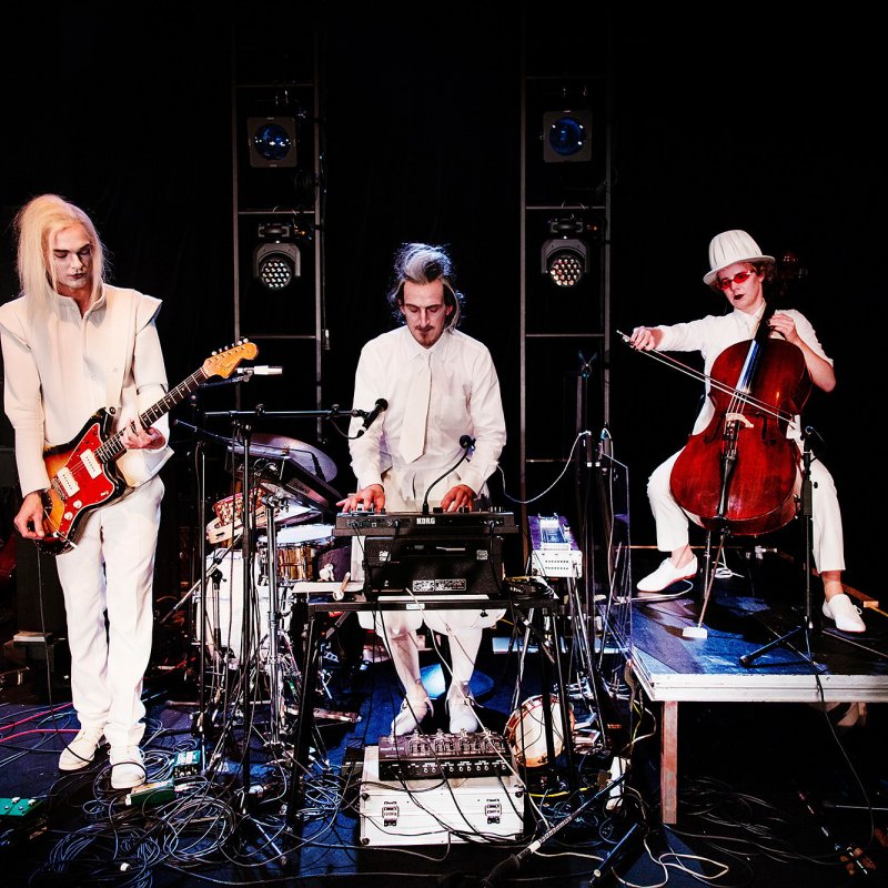 Det vitklädda bandet spelar cello, synth och gitarr.
