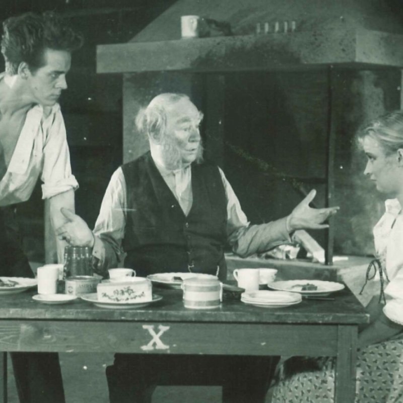 tre personer diskuterar vid bord