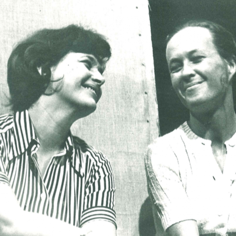 två kvinnor skrattar bredvid varandra