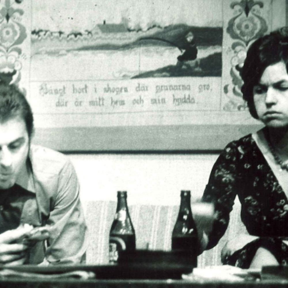 man och kvinna sitter uppgivet vid bord